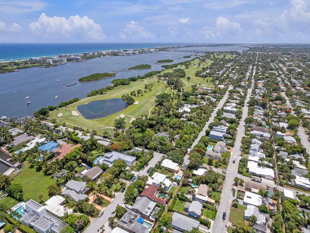 An aerial view shows a residential neighborhood bordering a golf course and a coastal waterway — 1615 N Lakeside Drive, FL 33460, FL
