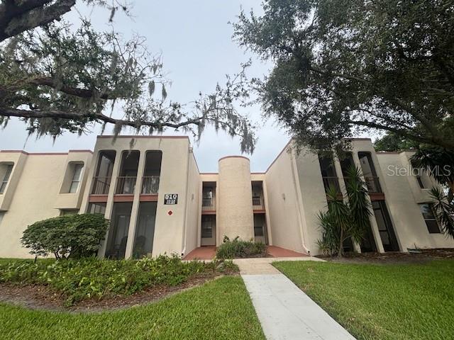 A two-story apartment building with a central cylindrical tower and screened balconies — 510 ORANGE DRIVE UNIT 20, ALTAMONTE SPRINGS, FL