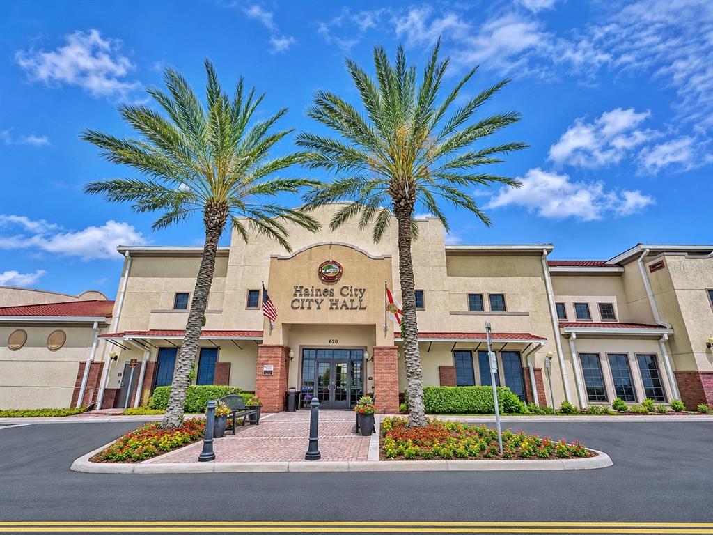 The exterior of Haines City City Hall features a tan facade with palm trees — 35 N 6TH STREET UNIT 1, HAINES CITY, FL
