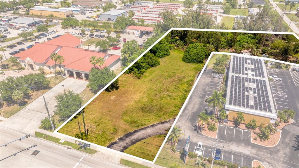 An aerial view shows a vacant grassy lot situated between two commercial buildings and parking lots — 1500 TAMIAMI TRAIL, PUNTA GORDA, FL