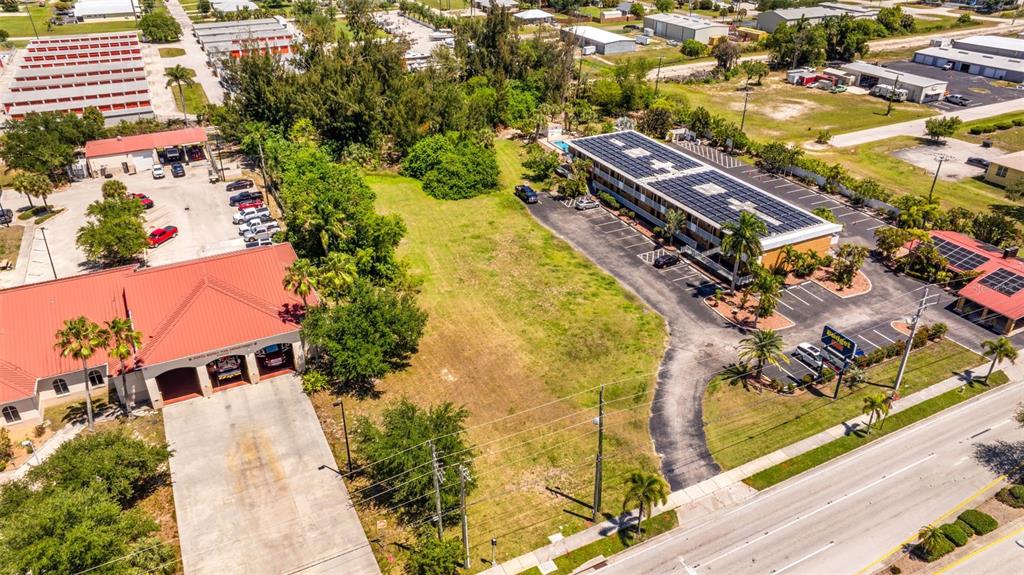 An aerial view shows a vacant lot situated between a fire station and a motel — 1500 TAMIAMI TRAIL, PUNTA GORDA, FL
