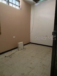 An empty room with light-colored walls, a tiled floor, and a high window — 26 CORCHADO, AGUADILLA, PR