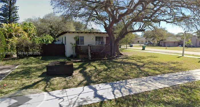 A small, single-story house with a wooden porch sits on a grassy lot with trees — 6151 SW 35th St # 1, Miramar FL 33023, MIRAMAR, FL