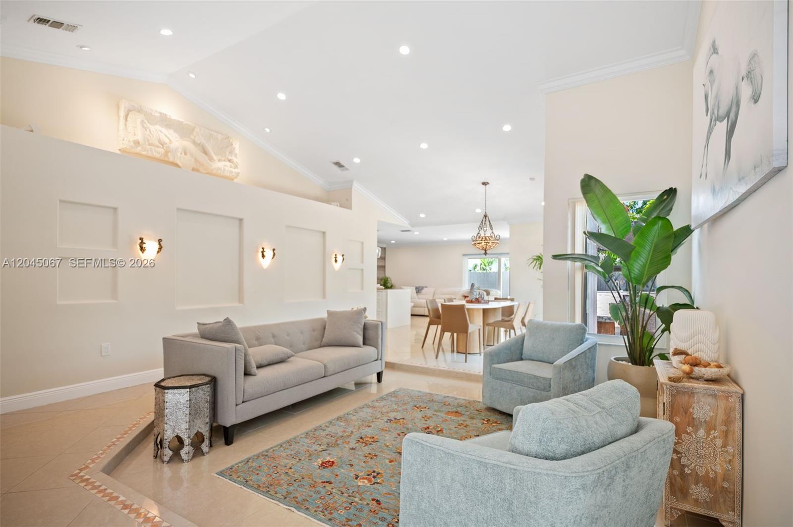 A living room with a grey sofa, two light blue armchairs, and a patterned rug — 982 NW 133rd Ct # 0, Miami FL 33182, MIAMI, FL
