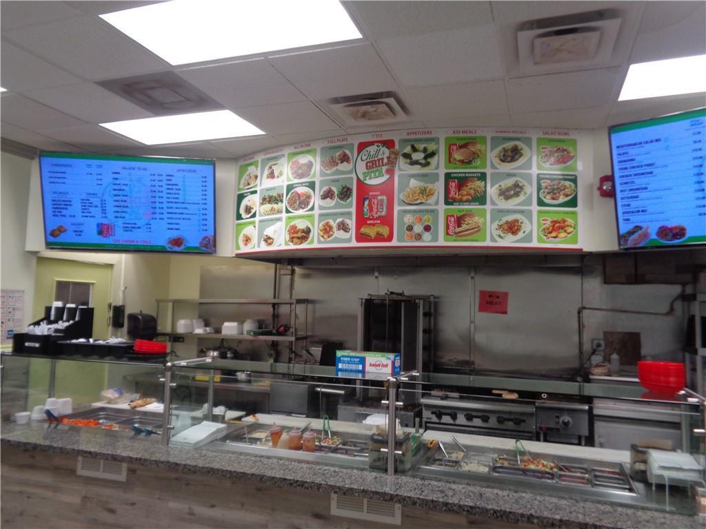 A commercial kitchen features a service counter, food preparation area, and menu boards on display — 7158 N Beracasa Way, Boca Raton FL 33433, BOCA RATON, FL