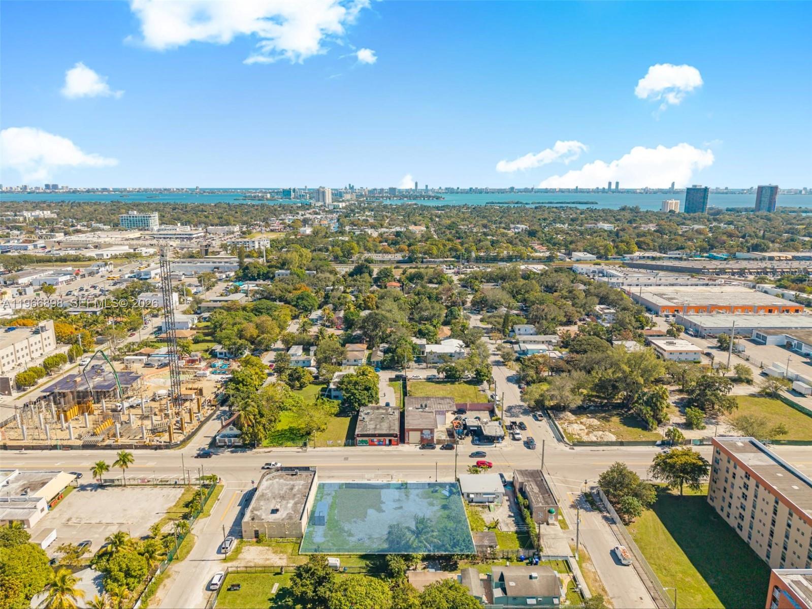 An aerial view shows a vacant rectangular lot surrounded by urban buildings and green trees — 7618 NE 2nd Ave, Miami FL 33138, MIAMI, FL