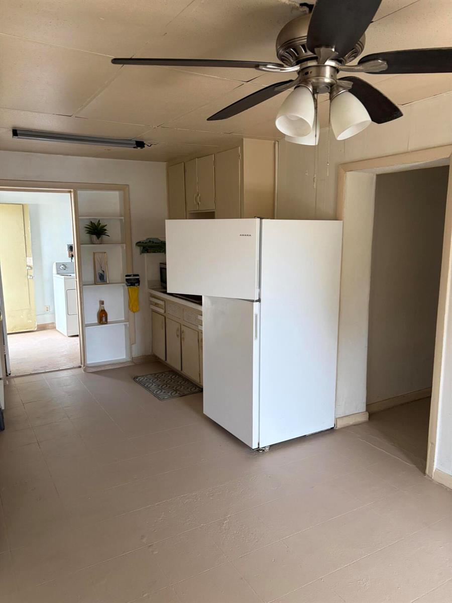 A kitchen features a white refrigerator, beige cabinets, and a ceiling fan — 198 SE 4th Street, Delray Beach FL 33483, DELRAY BEACH, FL