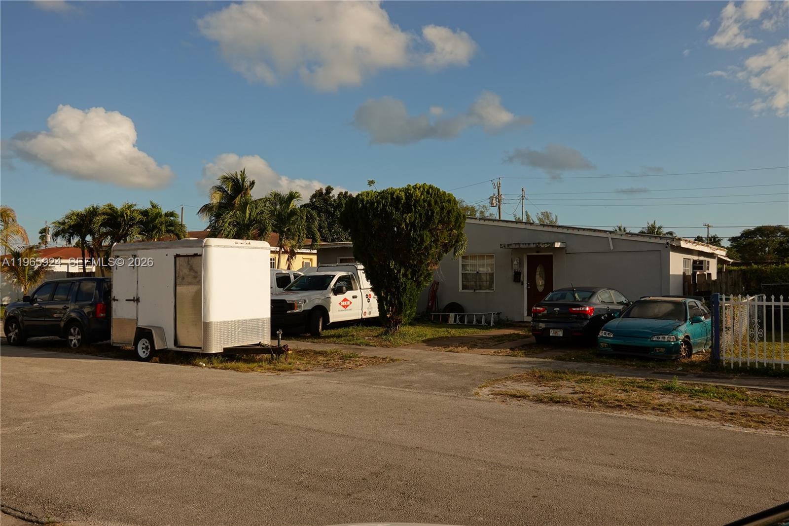 A single-story house with a driveway, a trailer, and several parked vehicles in the front — 810 NW 84th Ter, Miami FL 33150, MIAMI, FL