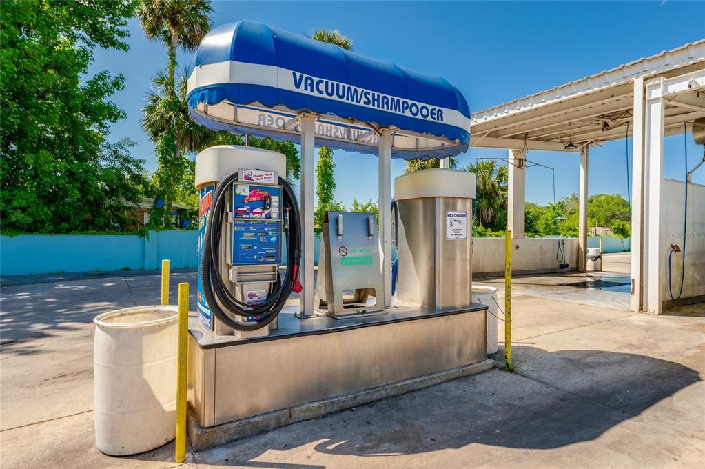 A car wash vacuum and shampooer station stands under a blue and white canopy — 1451 N NOVA ROAD, DAYTONA BEACH, FL