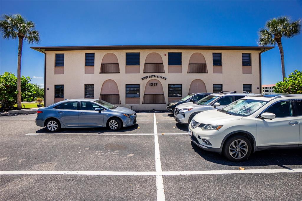A two-story apartment building with a parking lot in front and two palm trees — 1217 AQUI ESTA DRIVE UNIT 8, PUNTA GORDA, FL
