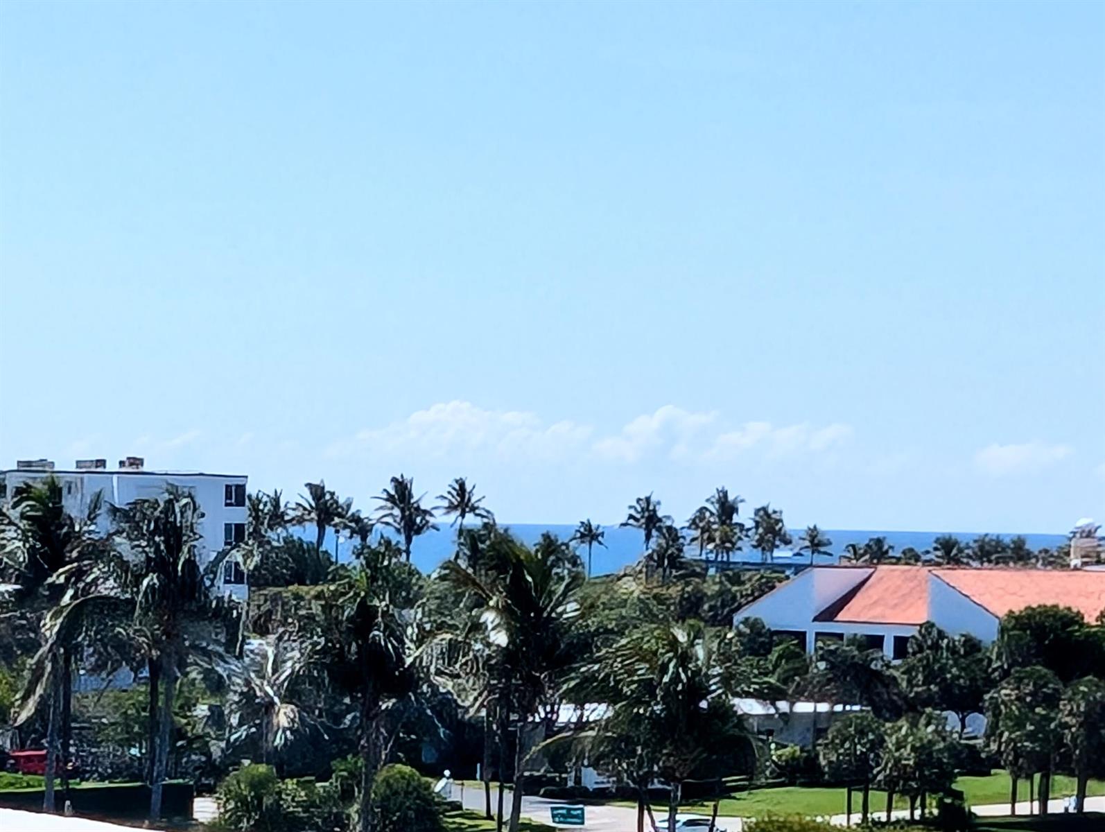 A view of palm trees, buildings, and the ocean under a clear blue sky — 2840 S Ocean Boulevard # 6110, Palm Beach FL 33480, PALM BEACH, FL