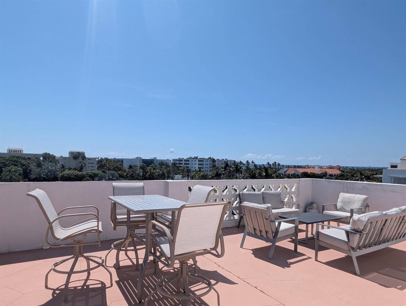 A rooftop terrace features outdoor dining and lounge furniture against a clear blue sky — 2840 S Ocean Boulevard # 6110, Palm Beach FL 33480, PALM BEACH, FL