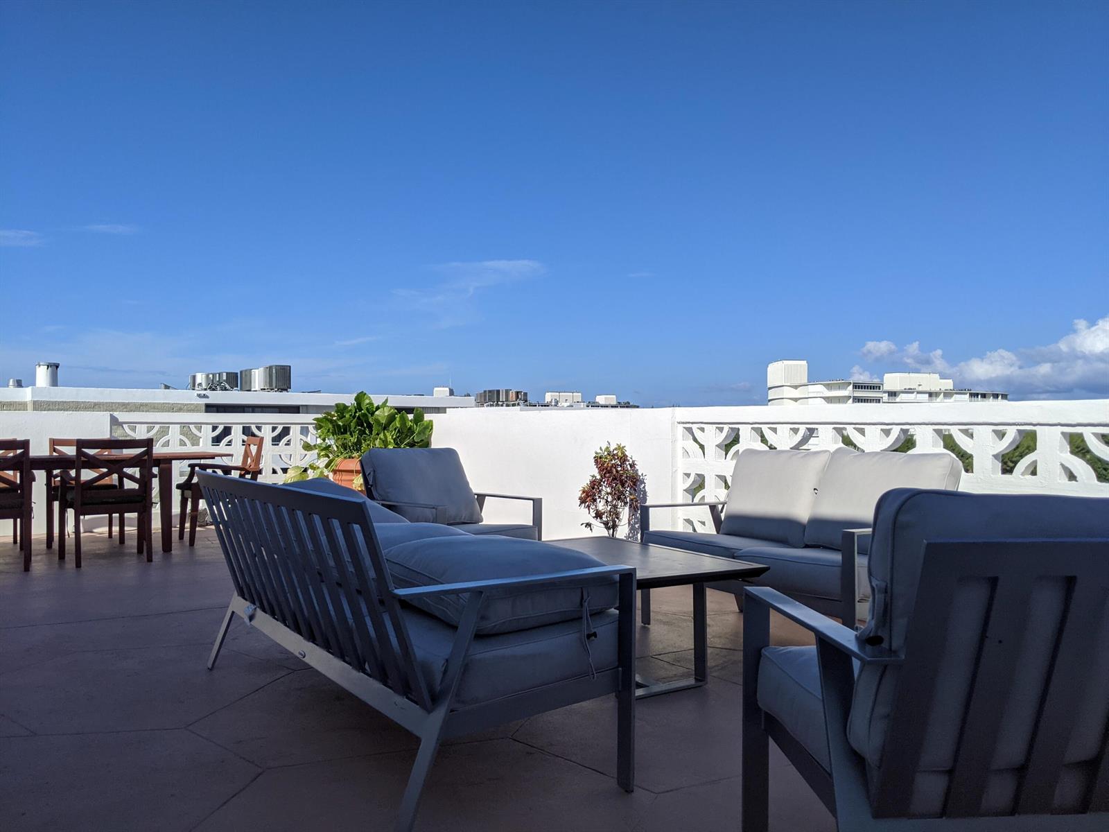 A rooftop terrace features outdoor lounge furniture, a dining set, and a decorative white railing — 2840 S Ocean Boulevard # 6110, Palm Beach FL 33480, PALM BEACH, FL