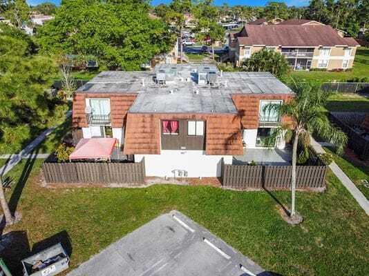 An aerial view of a two-story residential building with a brown mansard roof and patios — 2168 White Pine Circle # D, FL 33415, FL