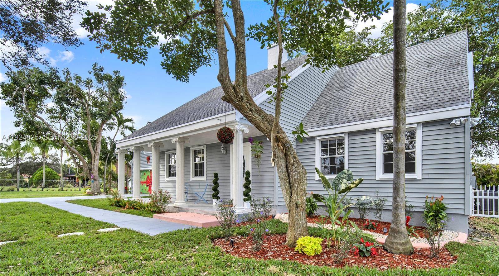 A gray, single-story house with a front porch, white columns, and a shingled roof — 22820 SW 179th Pl, Miami FL 33170, MIAMI, FL