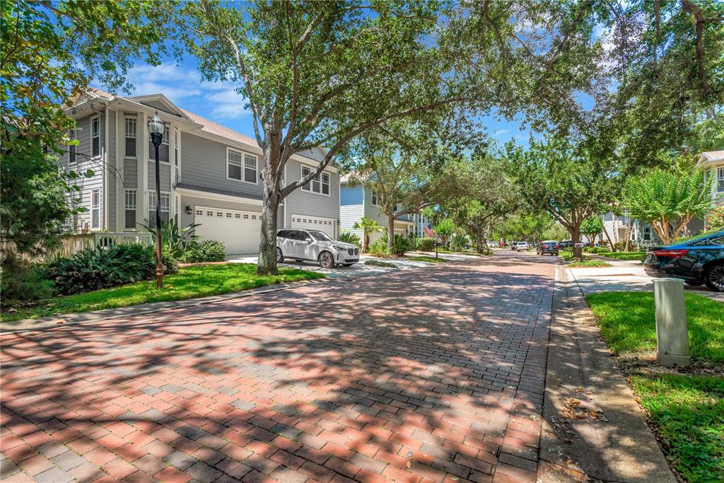 A two-story gray house with a two-car garage and a large tree in front — 2852 BAYSHORE TRAILS DR, TAMPA, FL