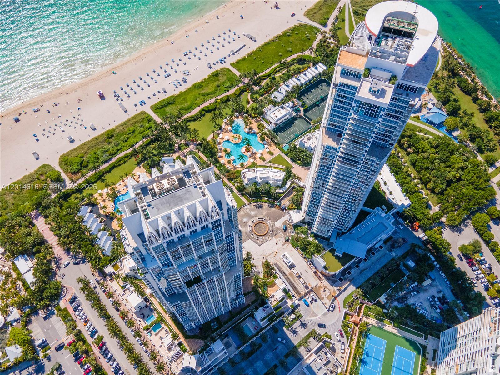 Aerial view of two high-rise residential towers near a beach with pools and tennis courts — 50 S Pointe Dr # 607, Miami Beach FL 33139, MIAMI BEACH, FL