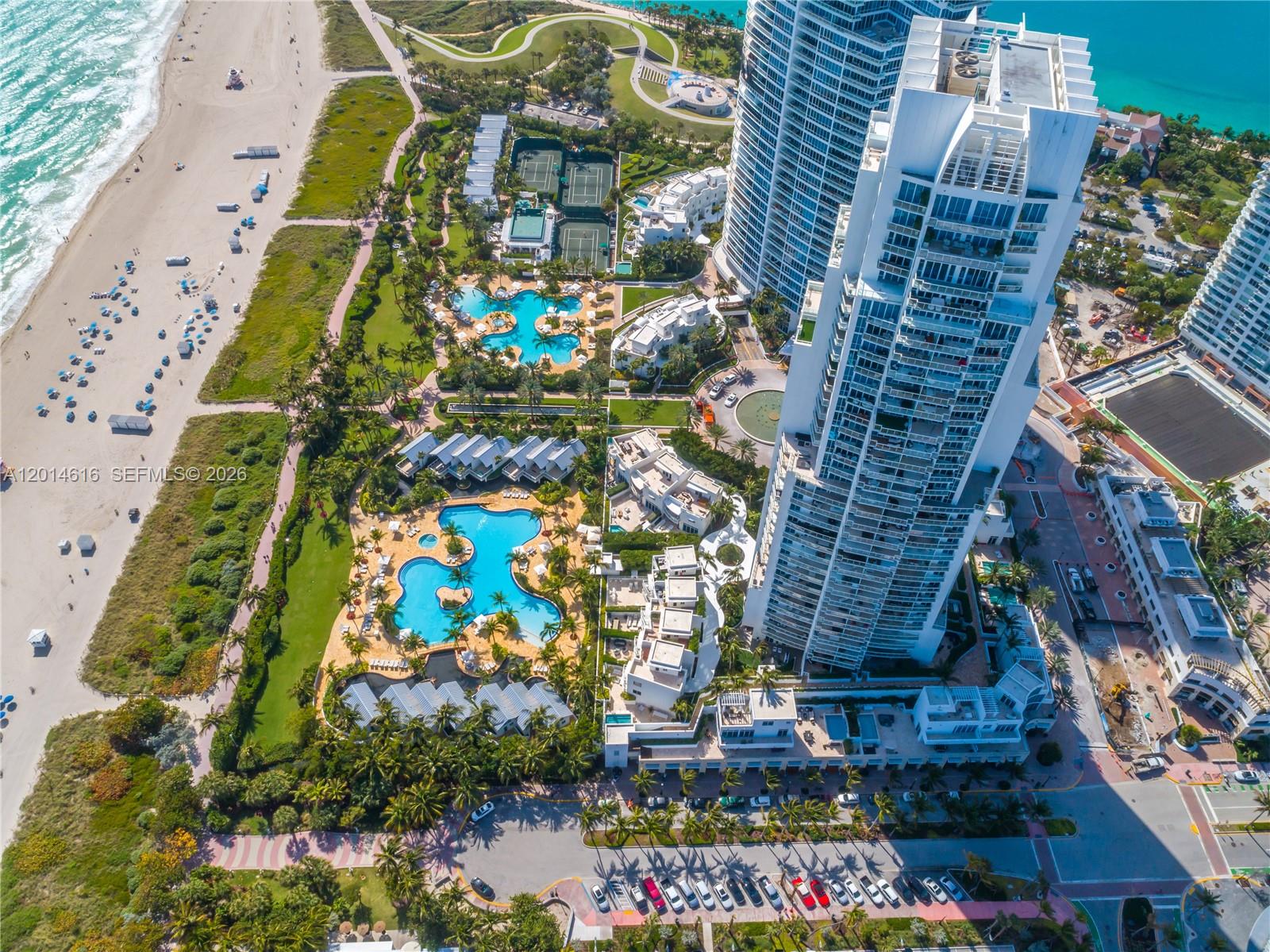 Aerial view of a coastal high-rise residential complex with swimming pools and tennis courts — 50 S Pointe Dr # 607, Miami Beach FL 33139, MIAMI BEACH, FL