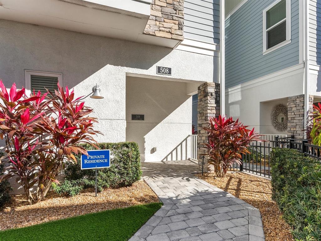 A stone-paved walkway leads to the entrance of a residence marked with the number 508 — 508 LAUREL PARK DRIVE, SARASOTA, FL