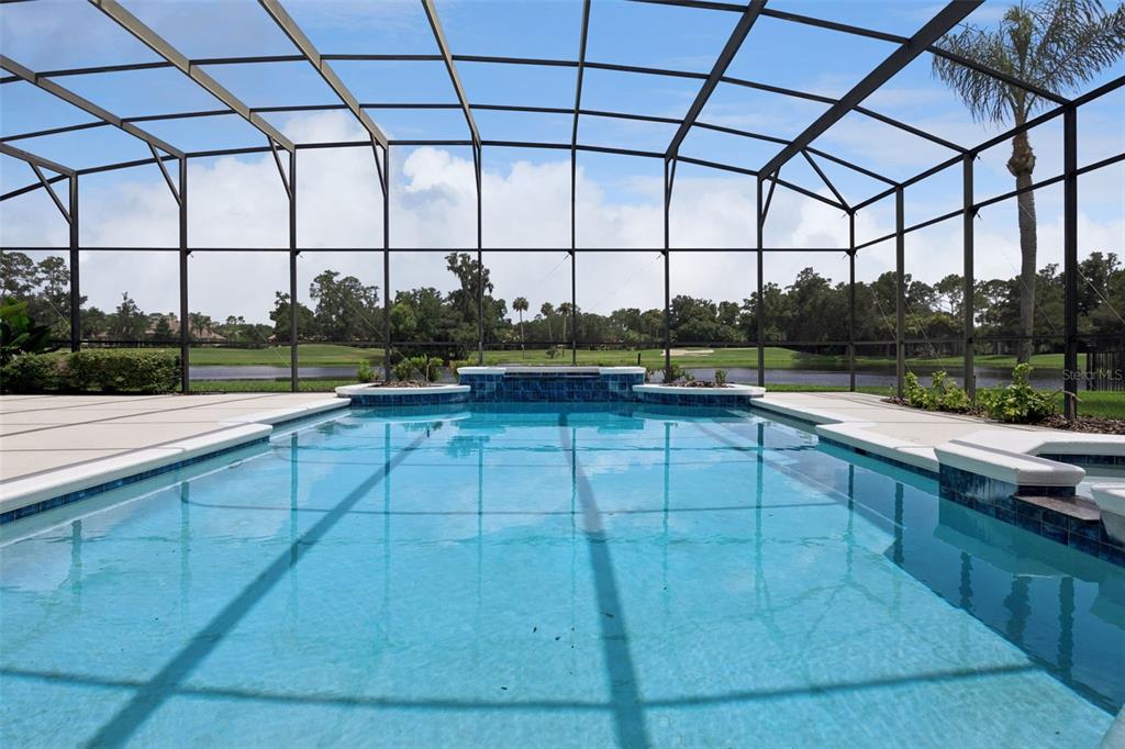 A screened-in swimming pool overlooks a lake and a golf course — 4013 BERMUDA GROVE PLACE, LONGWOOD, FL