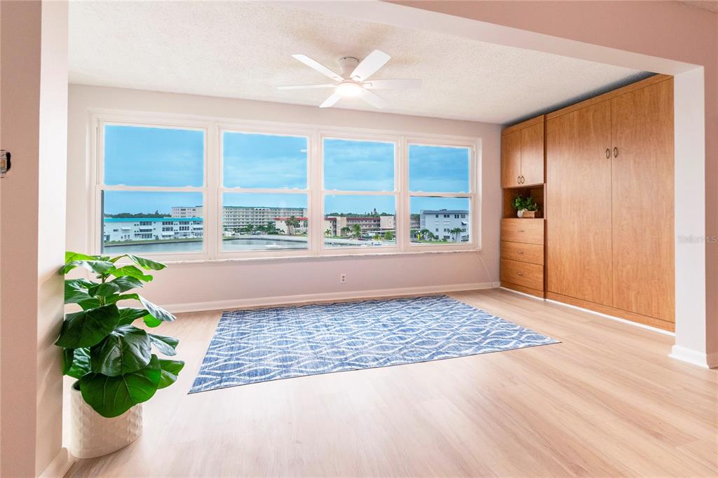 An entryway features a blue front door with a floral wreath and a hallway runner — 5925 SHORE BOULEVARD S UNIT 405, GULFPORT, FL