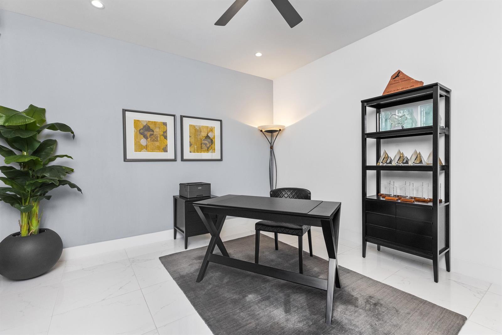 A modern home office features a black desk, chair, shelving unit, and a potted plant — 1851 NW 40th Drive, Boca Raton FL 33431, BOCA RATON, FL