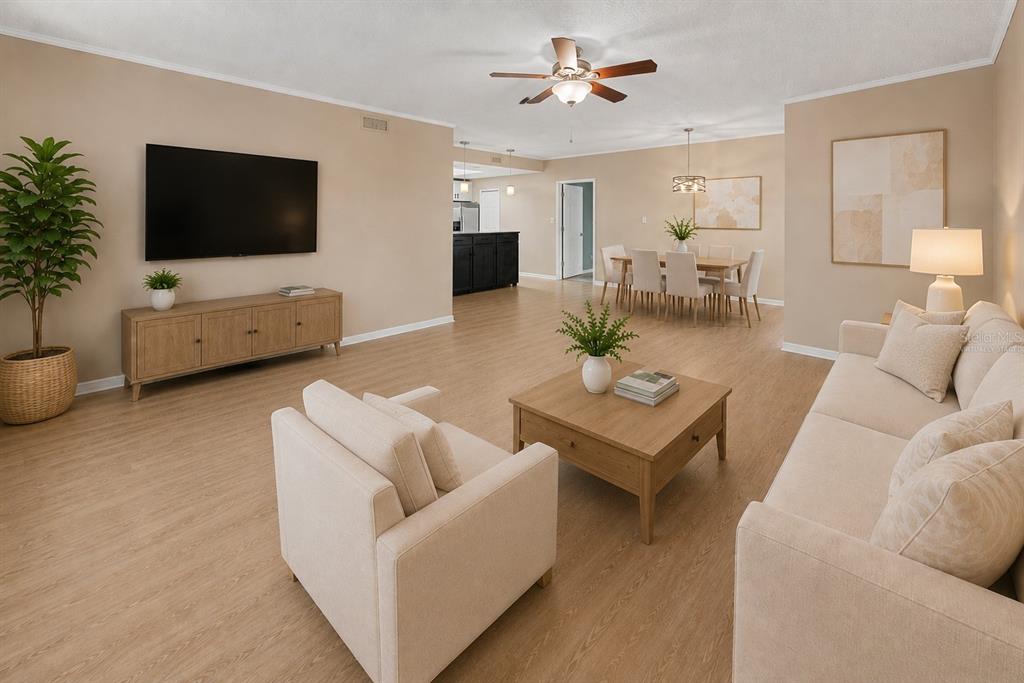 A living room and dining area feature light wood flooring, neutral walls, and modern furniture — 8350 SAVANNAH TRACE CIRCLE UNIT 106, TAMPA, FL