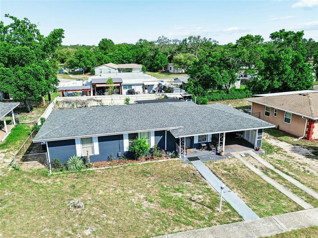 An aerial view of a single-story house with a dark exterior and a gray roof — 6395 TREEHAVEN DRIVE, SPRING HILL, FL