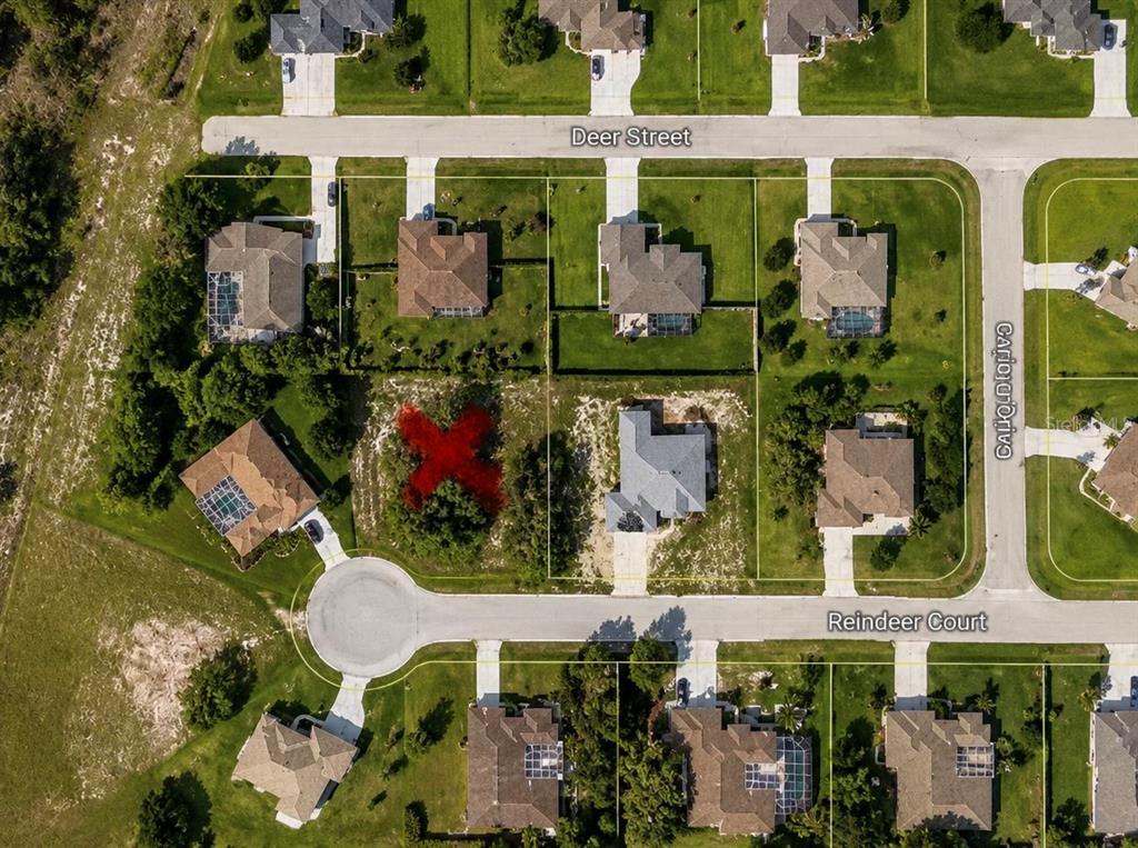 An aerial map view shows a residential neighborhood with a vacant lot marked with an X — 9925 REINDEER COURT, SPRING HILL, FL