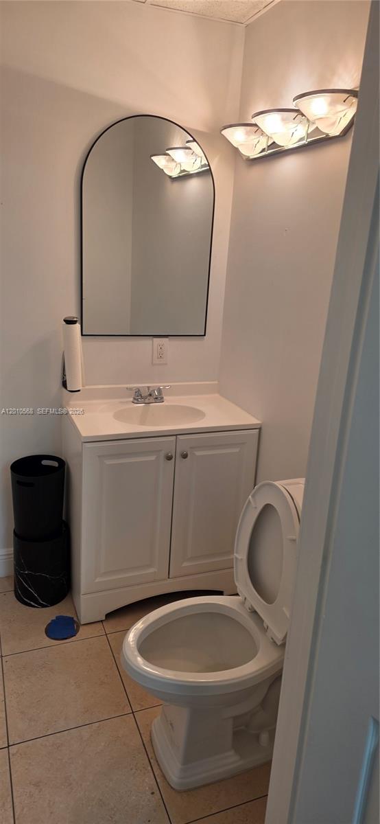 A small bathroom features a white vanity, a round-top mirror, and a white toilet — 4503 NW 103rd Ave # 104, Sunrise FL 33351, SUNRISE, FL