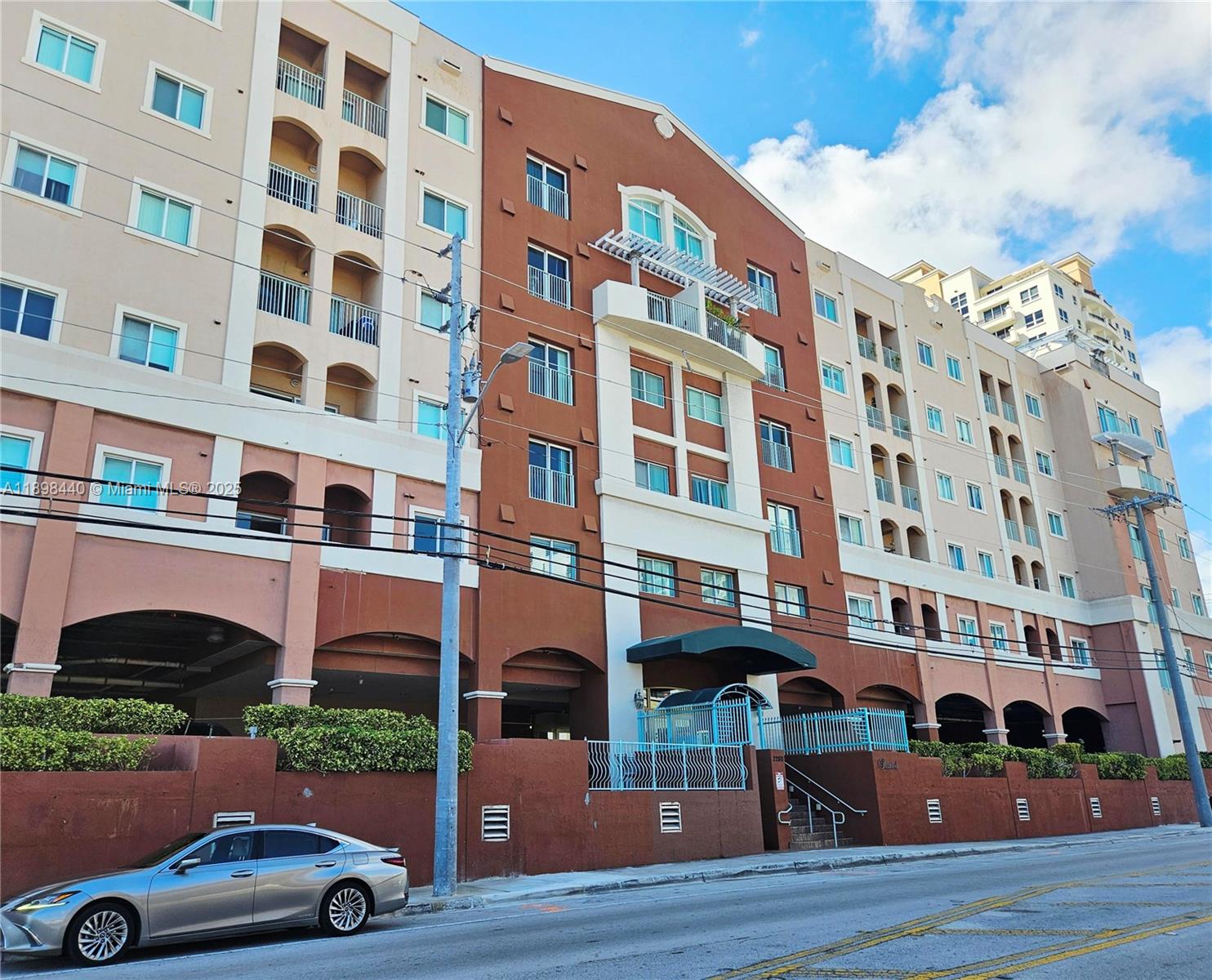 A multi-story apartment building with a brown and beige facade stands along a street — 2280 SW 32nd Ave # 511, Miami FL 33145, MIAMI, FL