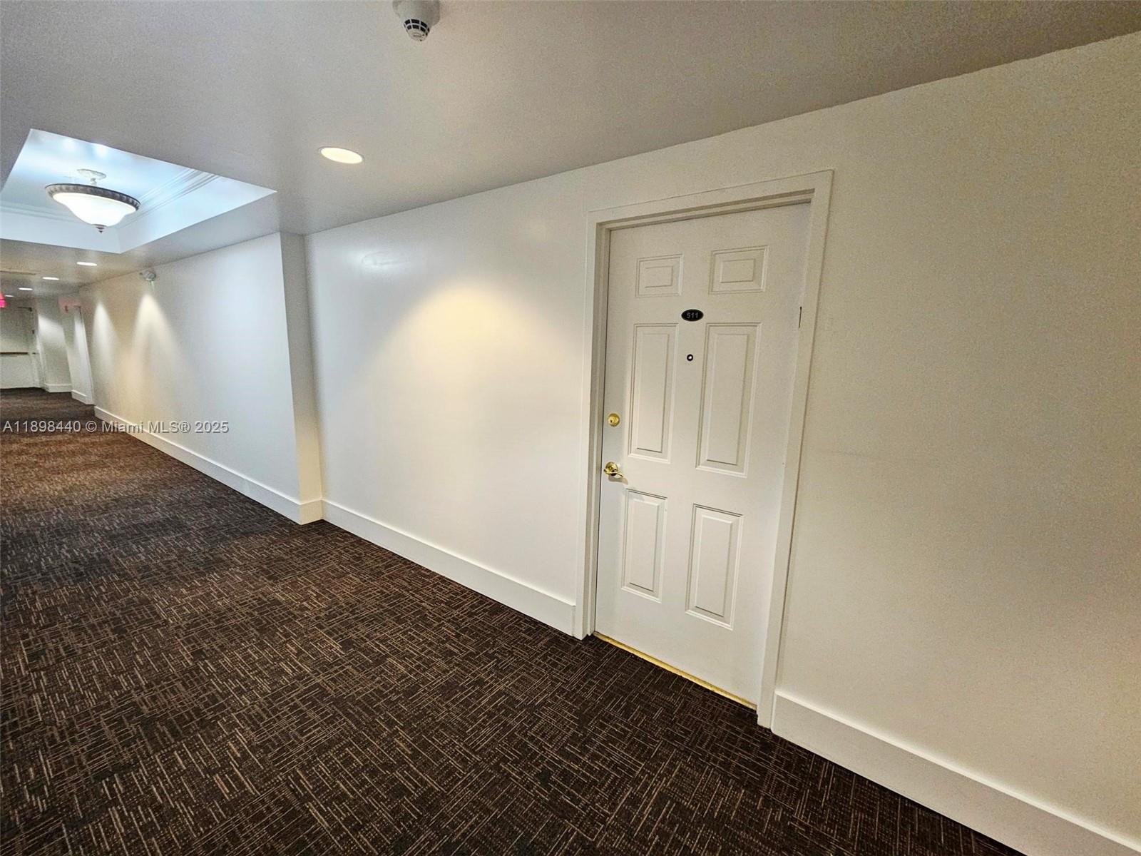 A white door labeled 511 sits in a hallway with dark patterned carpeting — 2280 SW 32nd Ave # 511, Miami FL 33145, MIAMI, FL
