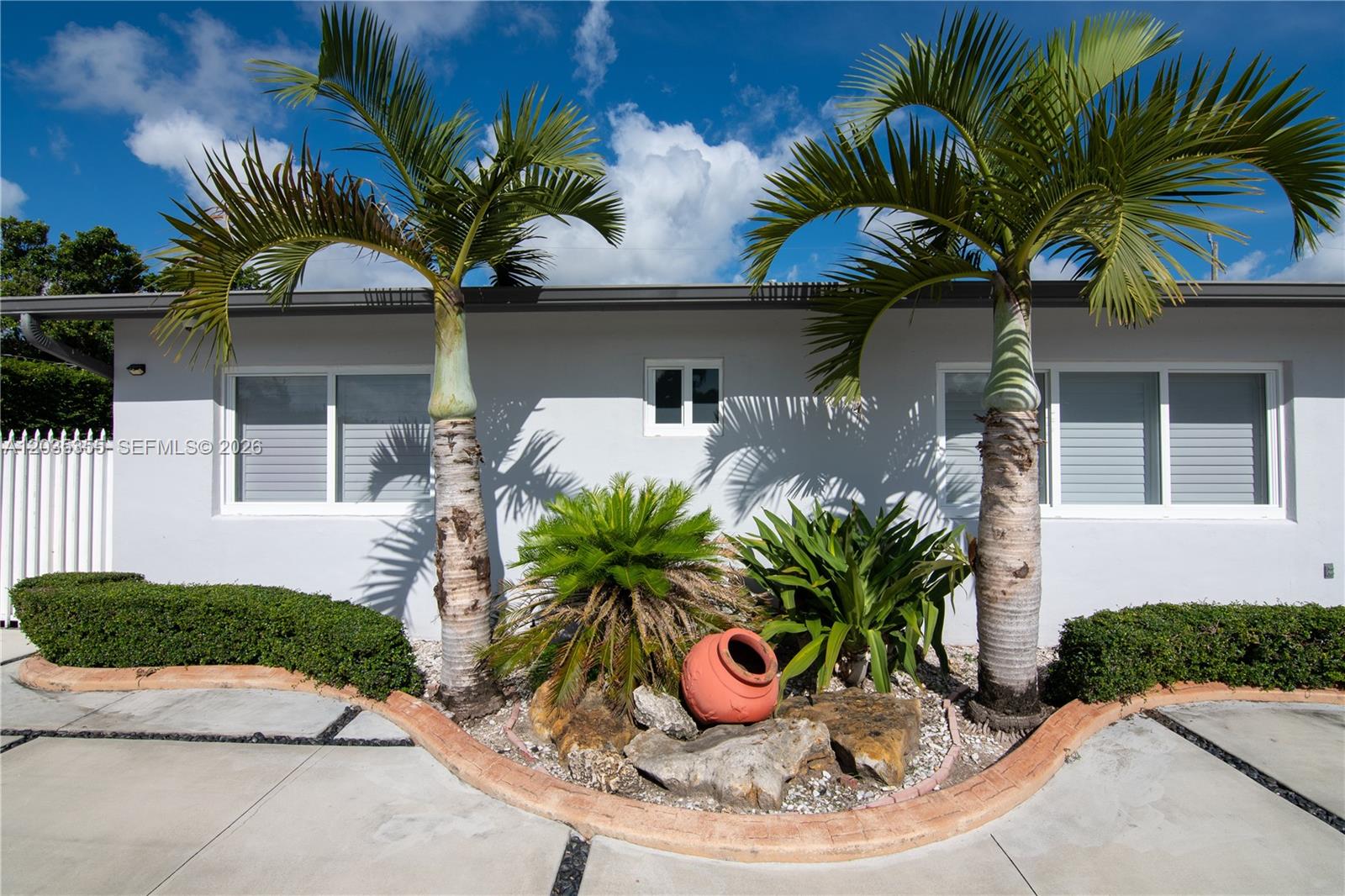 A light-colored house exterior features two palm trees, a small garden bed, and a terracotta pot — 3030 SW 96th Ave, Miami FL 33165, MIAMI, FL