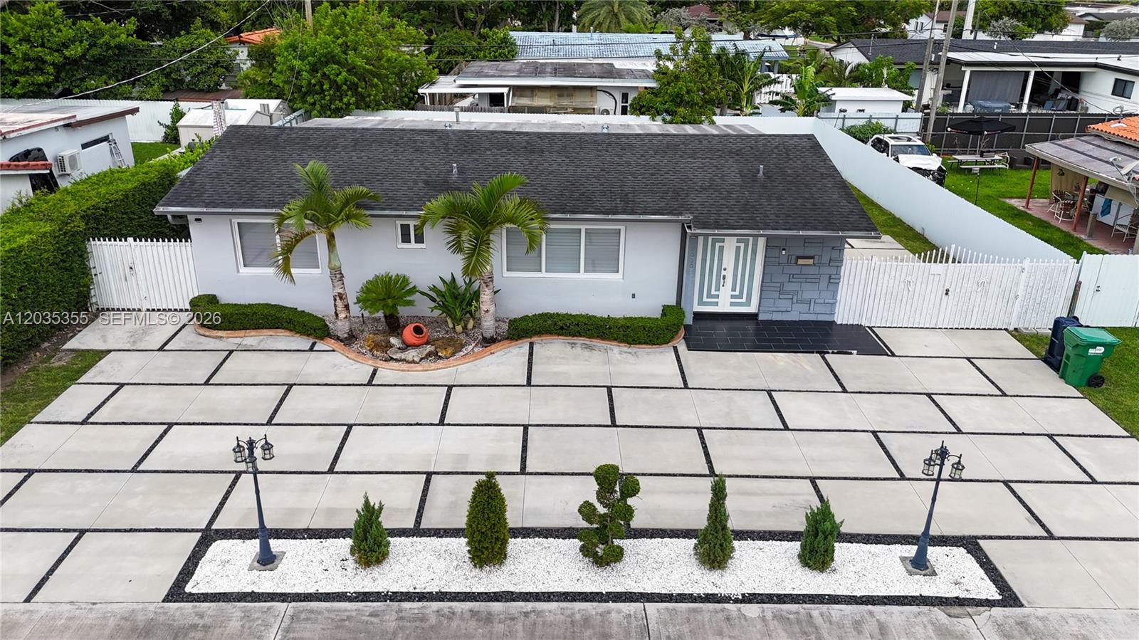 An aerial view shows a single-story house with a large paved driveway and landscaping — 3030 SW 96th Ave, Miami FL 33165, MIAMI, FL