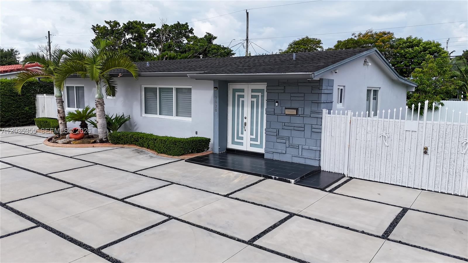 A single-story house features a gray exterior, a paved driveway, and a white double door — 3030 SW 96th Ave, Miami FL 33165, MIAMI, FL