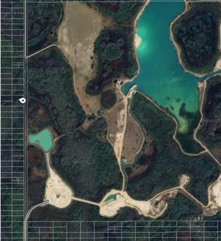 An aerial map view shows a large plot of land featuring several bodies of water — 26 NO STREET, POLK CITY, FL