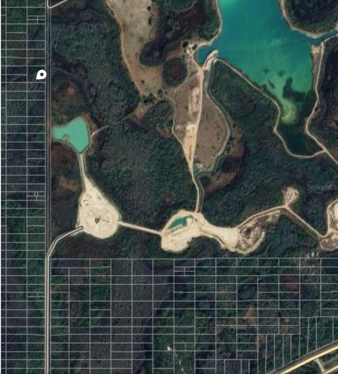 This is an aerial map view showing undeveloped land, dirt roads, and several small ponds — 26 NO STREET, POLK CITY, FL