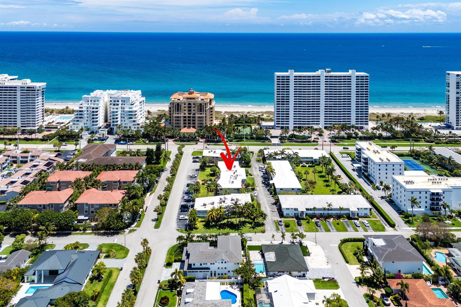 An aerial view shows a low-rise apartment complex near the beach with a red arrow — 930 Osceola Drive # 9, Boca Raton FL 33432, BOCA RATON, FL