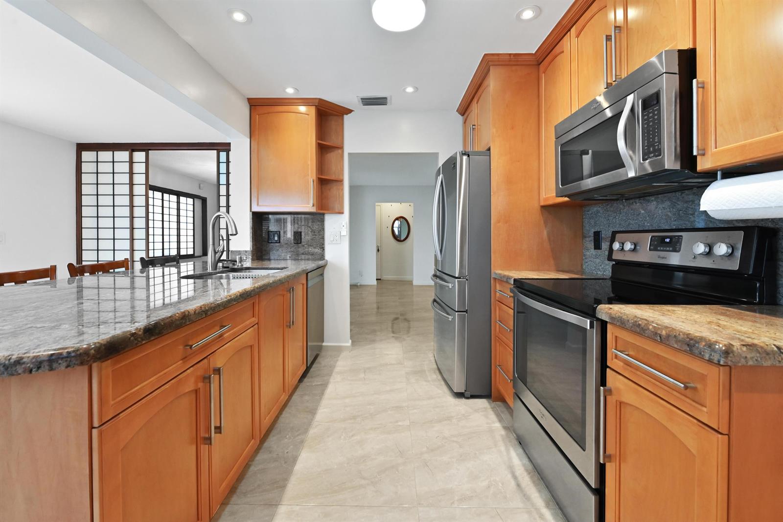 A kitchen with wood cabinets, stainless steel appliances, and granite countertops on a tile floor — 2012 SW 17th Avenue, Boynton Beach FL 33426, BOYNTON BEACH, FL