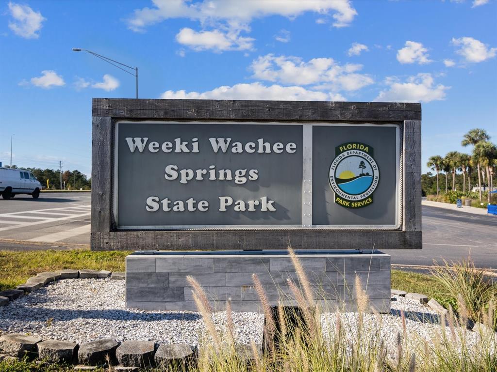 An aerial view shows Weeki Wachee Springs State Park with a waterpark, slides, and parking — Lot 9 COMMERCIAL WAY, BROOKSVILLE, FL