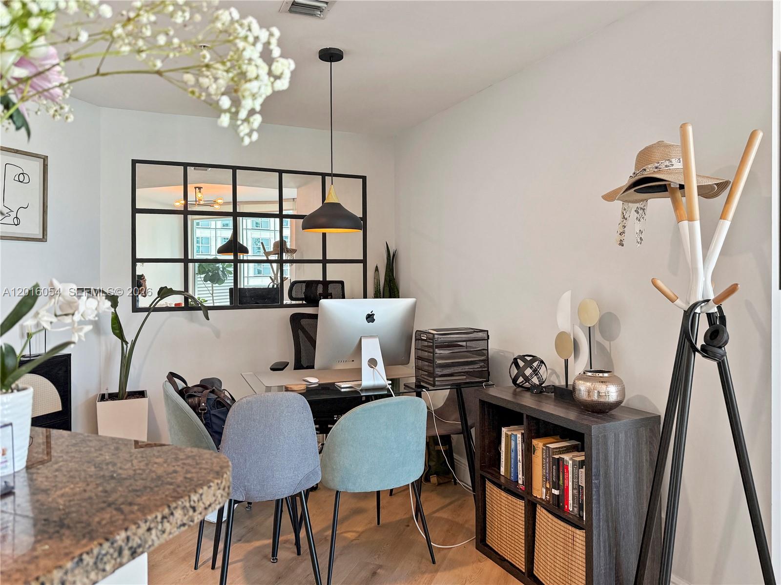 An open-concept living area features a home office, kitchen with a breakfast bar, and balcony — 300 S Biscayne Blvd # 1705, Miami FL 33131, MIAMI, FL