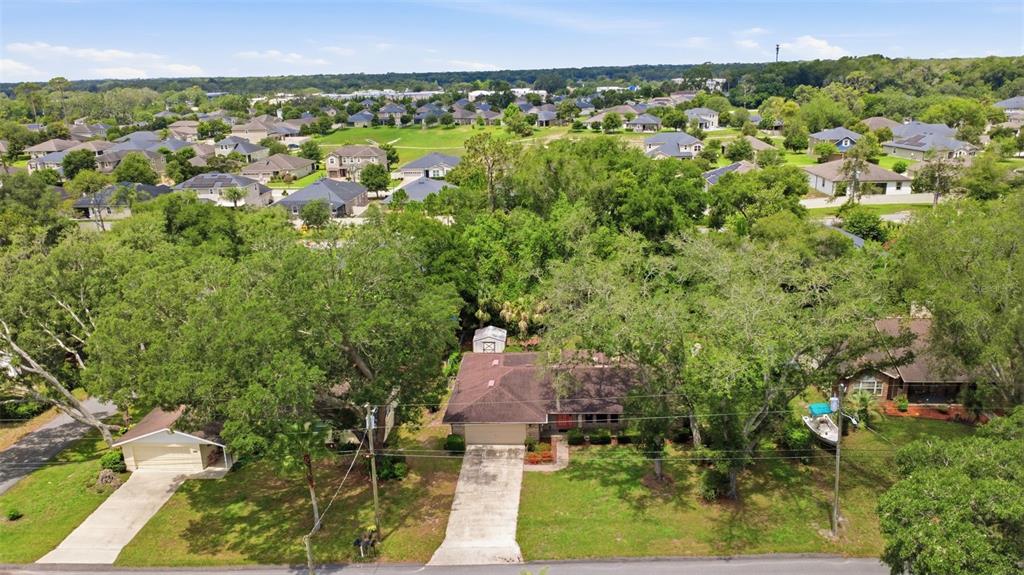 An aerial view shows a suburban house with a brown roof and two concrete driveways — 2360 DARTMOUTH ROAD, DELAND, FL