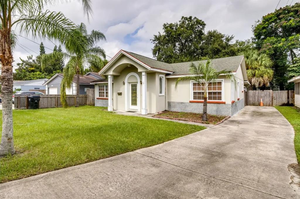 A single-story house with a concrete driveway, a front porch, and a grassy lawn — 125 PAGE STREET, ORLANDO, FL