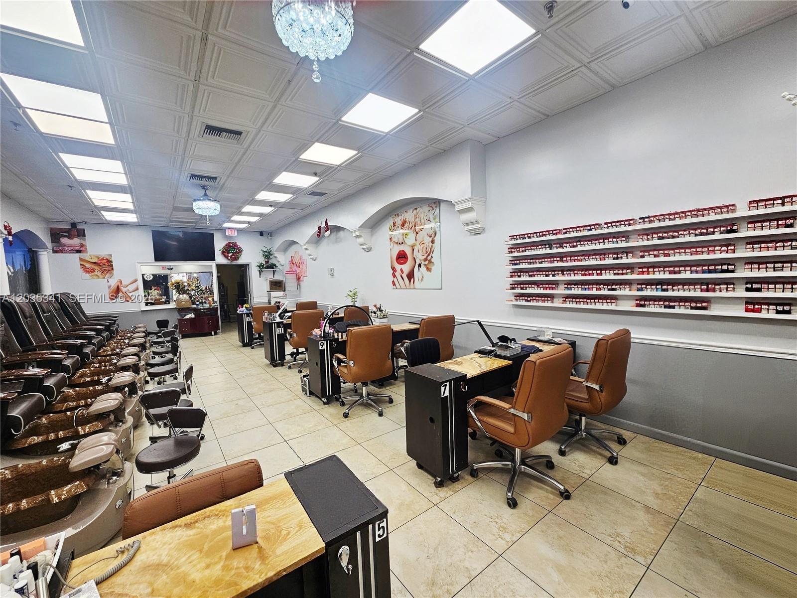 A nail salon features rows of pedicure chairs, manicure stations, and wall-mounted polish displays — 1455 NW 107, Doral FL 33172, DORAL, FL