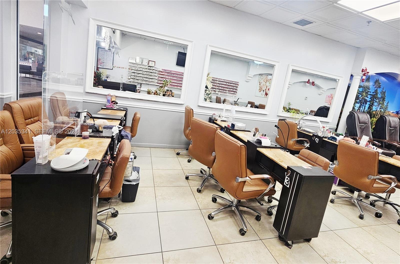 A nail salon features multiple manicure stations with tan chairs and wall-mounted mirrors — 1455 NW 107, Doral FL 33172, DORAL, FL