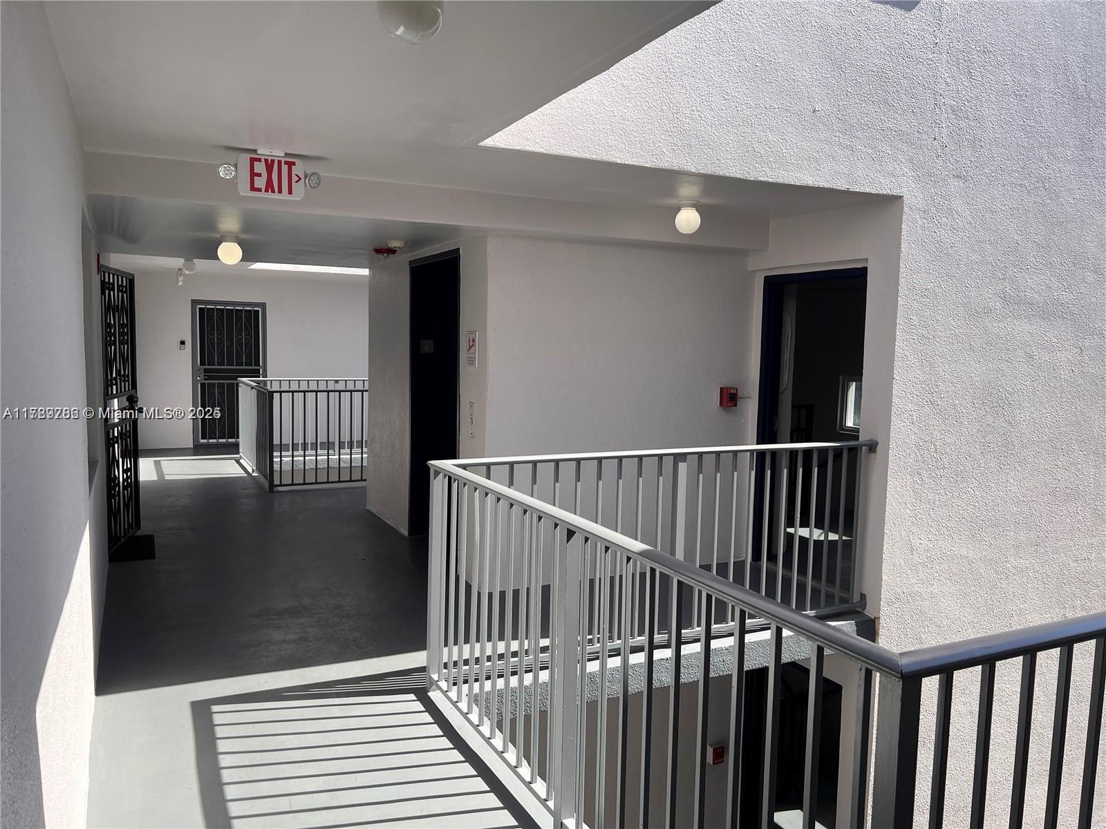 A view from a balcony overlooking a parking lot, trees, and several high-rise apartment buildings — 546 SW 1st St # 611, Miami FL 33130, MIAMI, FL