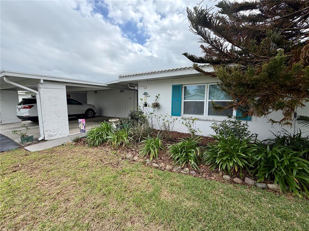 A one-story house with a white exterior, teal shutters, and a covered carport — 524 CAMEO DRIVE, LAKELAND, FL