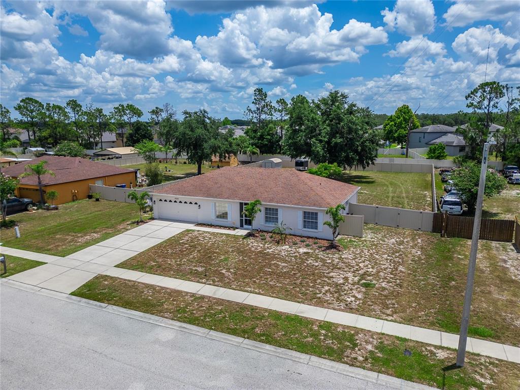 An aerial view shows a single-story house with a brown roof and a large yard — 12124 COLONIAL ESTATES LANE, RIVERVIEW, FL