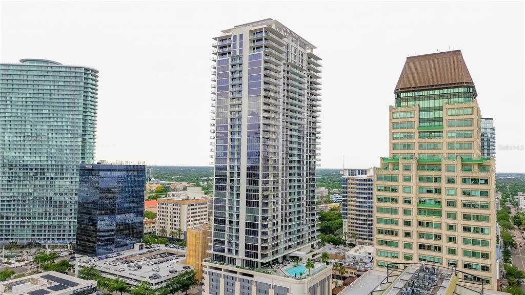 An aerial view of several high-rise buildings in a city skyline under a cloudy sky — 275 1ST AVENUE S UNIT 1504, ST PETERSBURG, FL