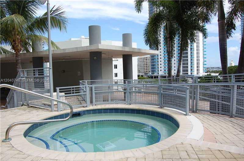 A circular outdoor hot tub sits on a paved deck surrounded by metal railings — 350 NE 24th St # 1109, Miami FL 33137, MIAMI, FL